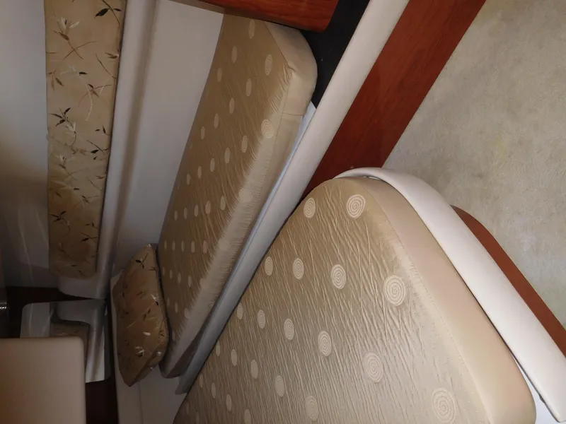 Slide: The Image of Interior cabin of 2007 Regal 4080 Sportyacht with beige patterned cushions. - 48