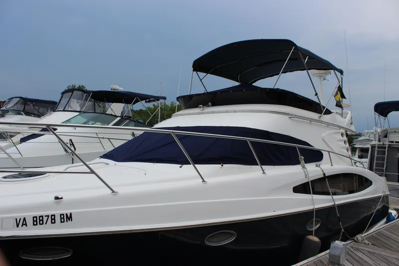 Slide: The Image of 2007 Regal 4080 Sportyacht docked at marina, featuring sleek design and black canopy. - 5
