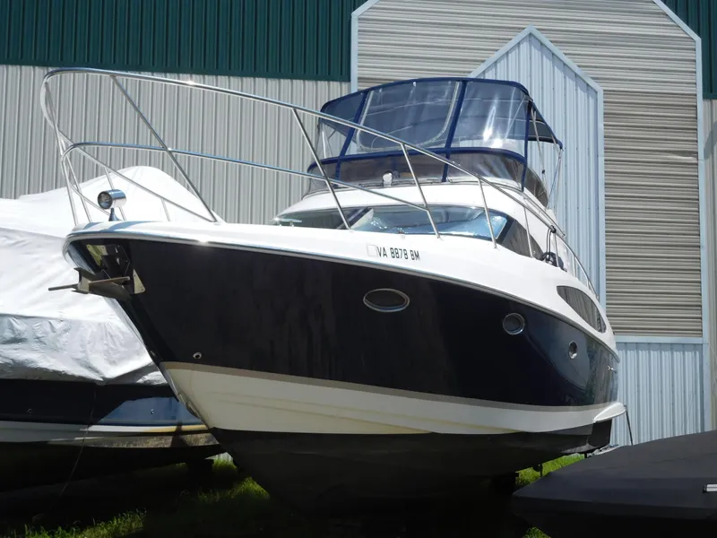 Slide: The Image of 2007 Regal 4080 Sportyacht docked near a boathouse. - 7