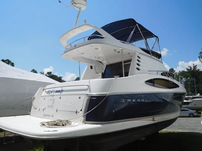 Slide: The Image of 2007 Regal 4080 Sportyacht with sleek design, docked under clear blue sky. - 9