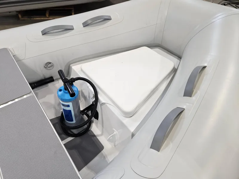 Slide: The Image of 2023 AB Inflatables 10 AL boat interior with pump and storage compartment. - 4