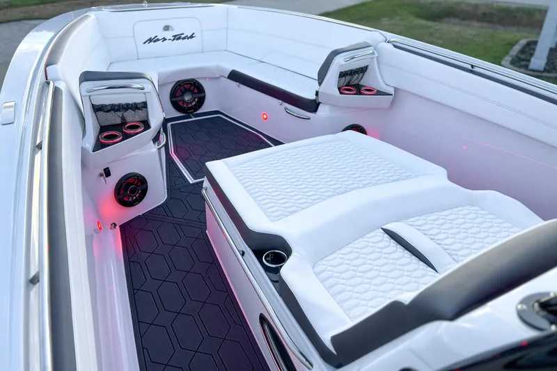 Slide: The Image of Luxurious interior of 2026 Nor-Tech 390 Sport boat with white seating and ambient lighting. - 19