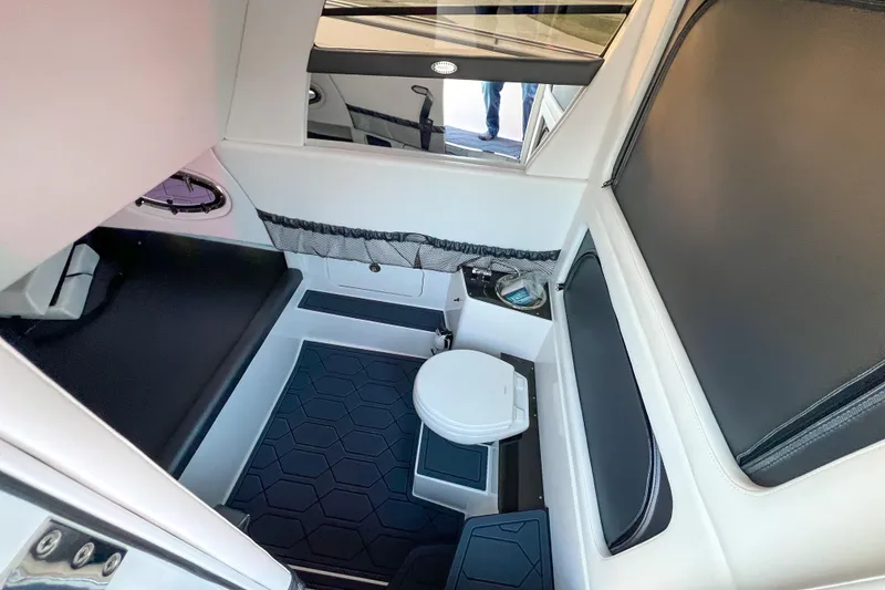 Slide: The Image of Interior cabin of 2026 Nor-Tech 390 Sport boat with seating and toilet. - 20