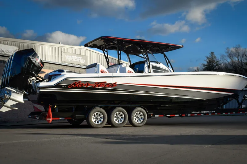 Slide: The Image of 2026 Nor-Tech 390 Sport boat on trailer, sleek design, powerful engines, outdoor setting. - 3