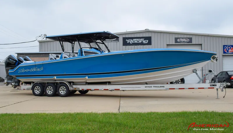 Slide: The Image of 2025 Nor-Tech 390 Sport boat in blue on a trailer outside a warehouse. - 4