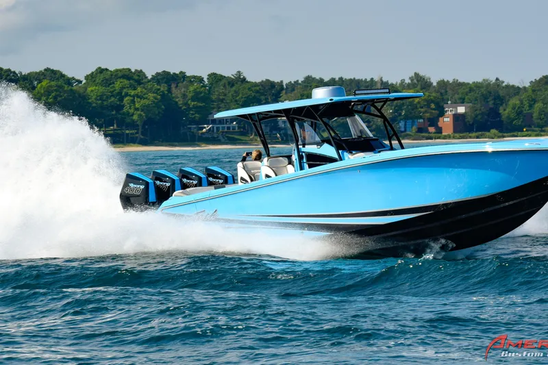 The Image of 2026 Nor-Tech 390 Sport boat speeding on water, vibrant blue, powerful engines, scenic background. - 0