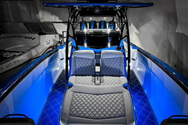 Slide: The Image of 2026 Nor-Tech 390 Sport boat interior with blue LED lighting and luxurious seating. - 17