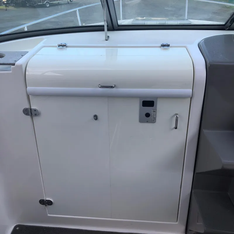 Slide: The Image of Control panel and storage compartment on a 2008 Rinker 230 Captiva boat. - 6