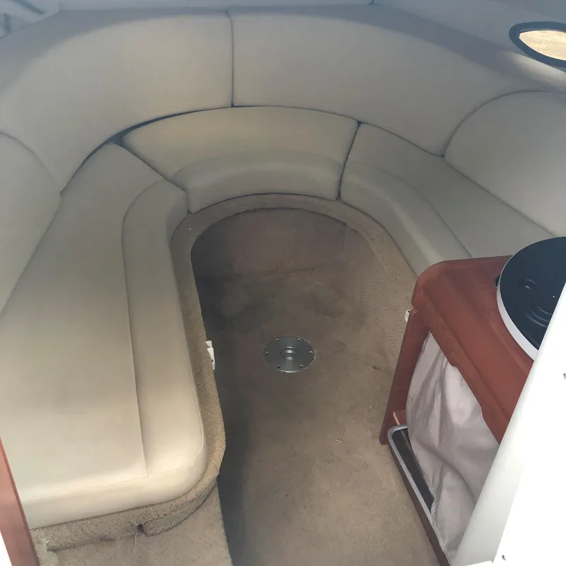 Slide: The Image of Interior cabin of a 2008 Rinker 230 Captiva boat with beige seating and carpet. - 7