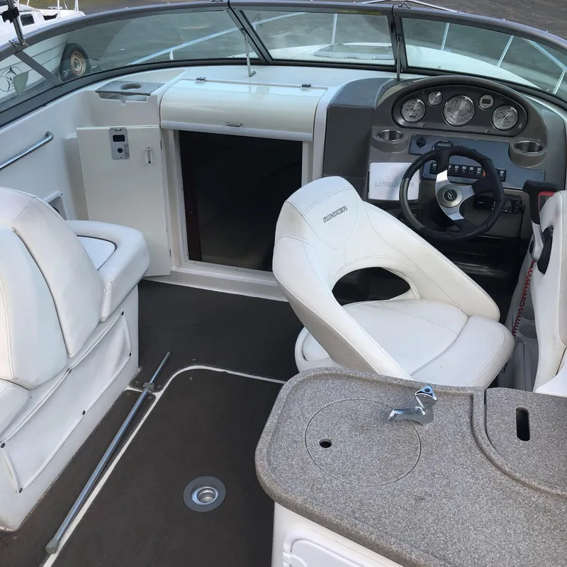 Slide: The Image of 2008 Rinker 230 Captiva boat interior with white seats and dashboard. - 8