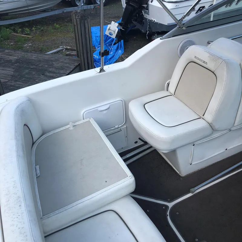 Slide: The Image of Interior seating of a 2008 Rinker 230 Captiva boat with white upholstery. - 9
