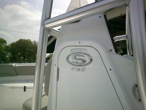 Slide: The Image of 2023 Sportsman 232 Open boat console with logo and seating area. - 13