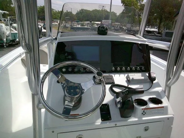 Slide: The Image of 2023 Sportsman 232 Open boat dashboard with steering wheel and electronic controls. - 8