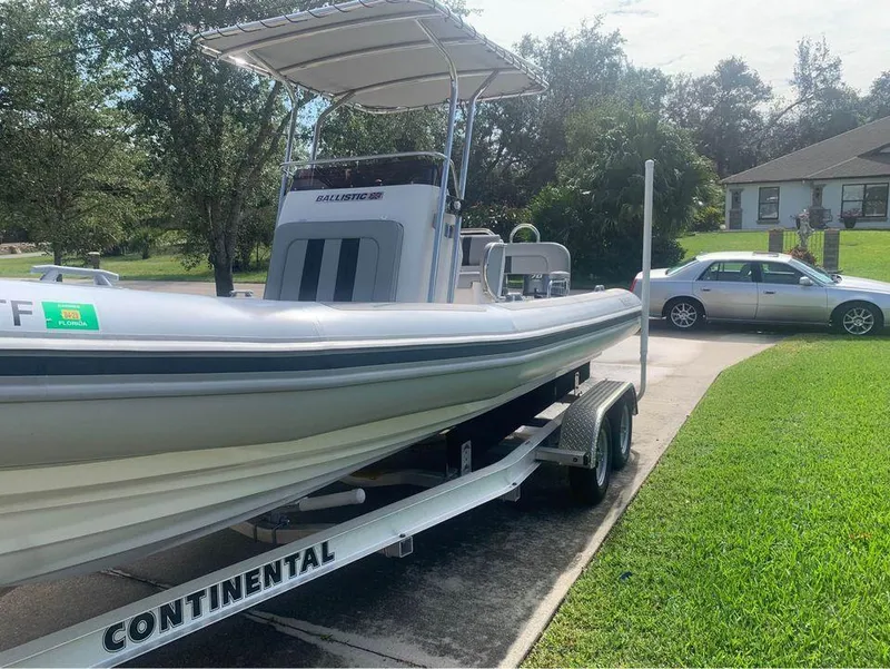 Slide: The Image of 2021 Ballistic RIB boat on Continental trailer in driveway. - 11