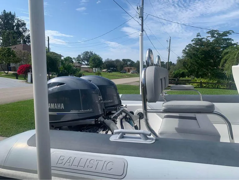 Slide: The Image of 2021 Ballistic RIB boat with twin Yamaha engines in a residential area. - 13