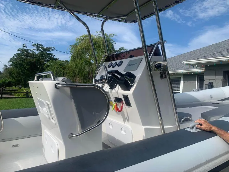 Slide: The Image of 2021 Ballistic RIB boat interior with steering console and seating. - 14