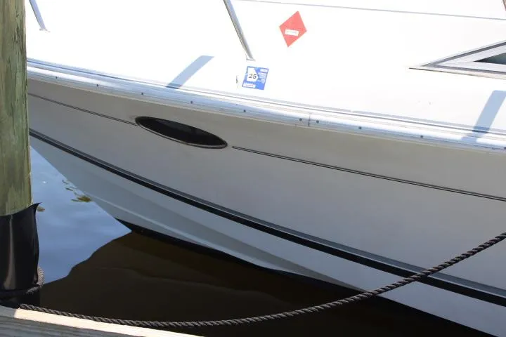 Slide: The Image of 2021 Ballistic RIB boat docked, side view showing hull and water reflection. - 15