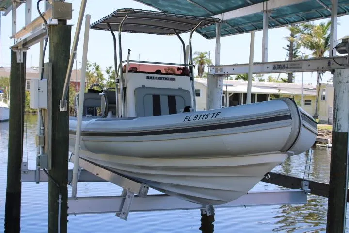Slide: The Image of 2021 Ballistic RIB boat on a lift in a marina. - 16