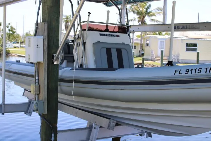 Slide: The Image of 2021 Ballistic RIB boat docked on a lift in a marina. - 17