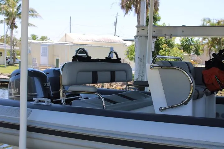 Slide: The Image of 2021 Ballistic RIB boat with Yamaha 70 outboard motor, docked near residential area. - 24
