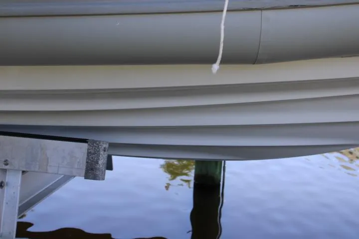 Slide: The Image of Close-up of a 2021 Ballistic RIB boat hull above water. - 25