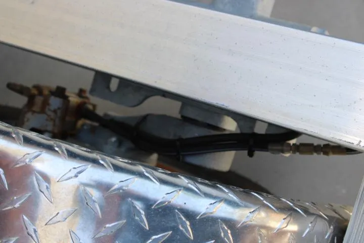 Slide: The Image of Close-up of 2021 Ballistic RIB trailer with diamond plate and hydraulic lines. - 31