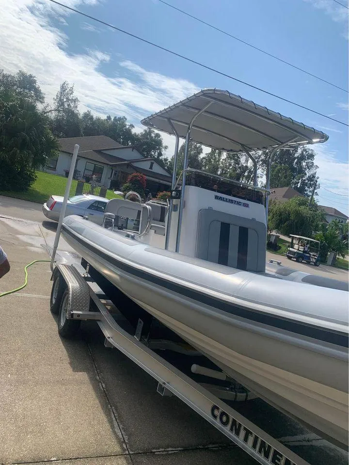 Slide: The Image of 2021 Ballistic RIB boat on trailer in residential driveway. - 9
