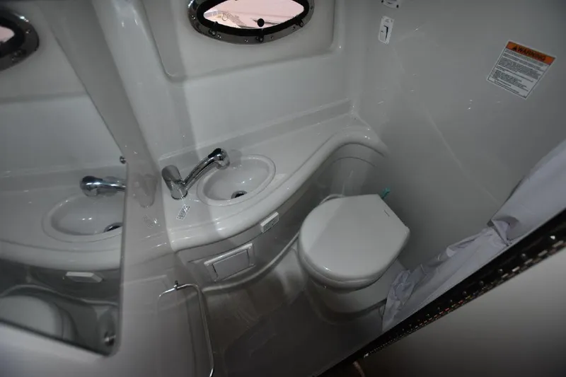 Slide: The Image of 2021 Crownline 264 CR boat bathroom with sink and toilet. - 10