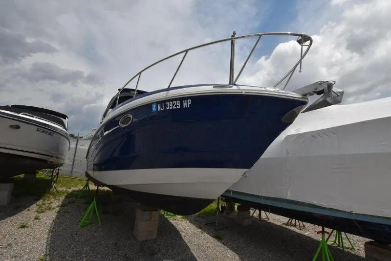 Slide: The Image of 2021 Crownline 264 CR boat on stands, front view. - 14