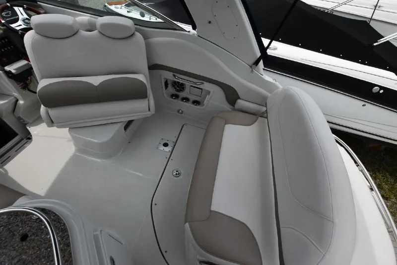 Slide: The Image of 2021 Crownline 264 CR boat interior with white and beige seating. - 18