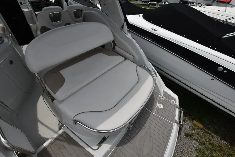Slide: The Image of 2021 Crownline 264 CR boat with white cushioned seating area. - 19