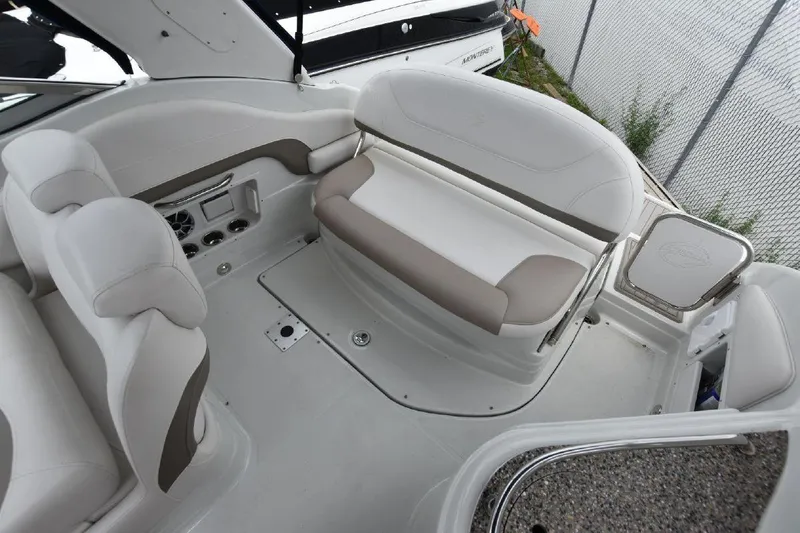 Slide: The Image of 2021 Crownline 264 CR boat interior with white and beige seating. - 23