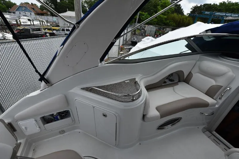 Slide: The Image of 2021 Crownline 264 CR boat interior with seating and storage compartments. - 24