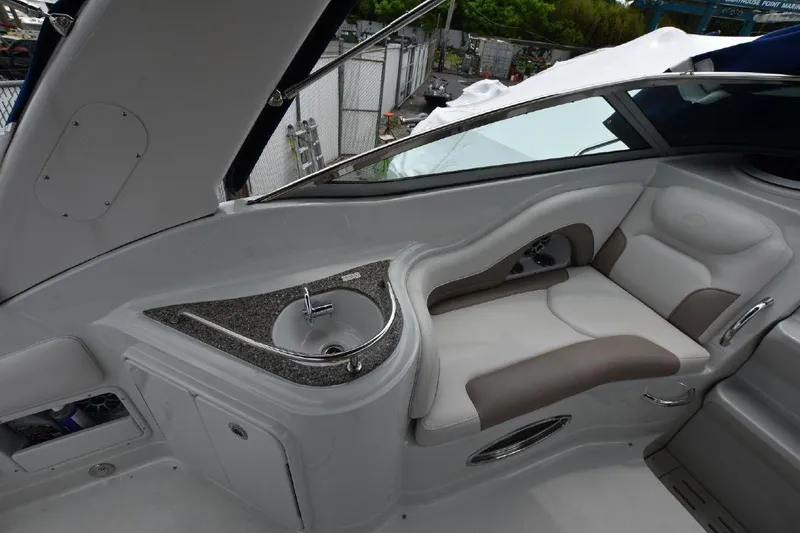 Slide: The Image of 2021 Crownline 264 CR boat interior with seating and sink. - 25