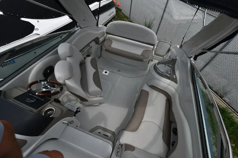 Slide: The Image of 2021 Crownline 264 CR boat interior with white and beige seating. - 26
