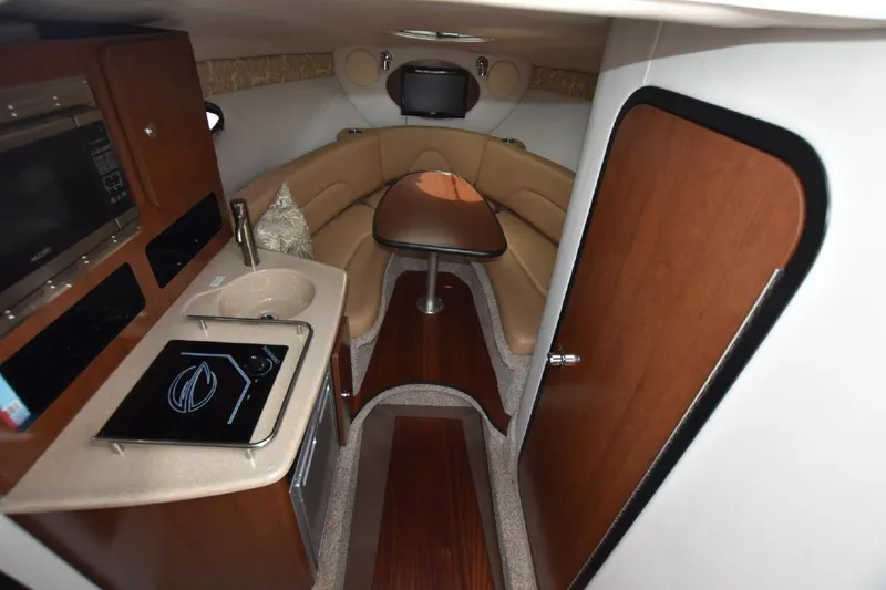 Slide: The Image of Interior of 2021 Crownline 264 CR boat with kitchenette and seating area. - 3