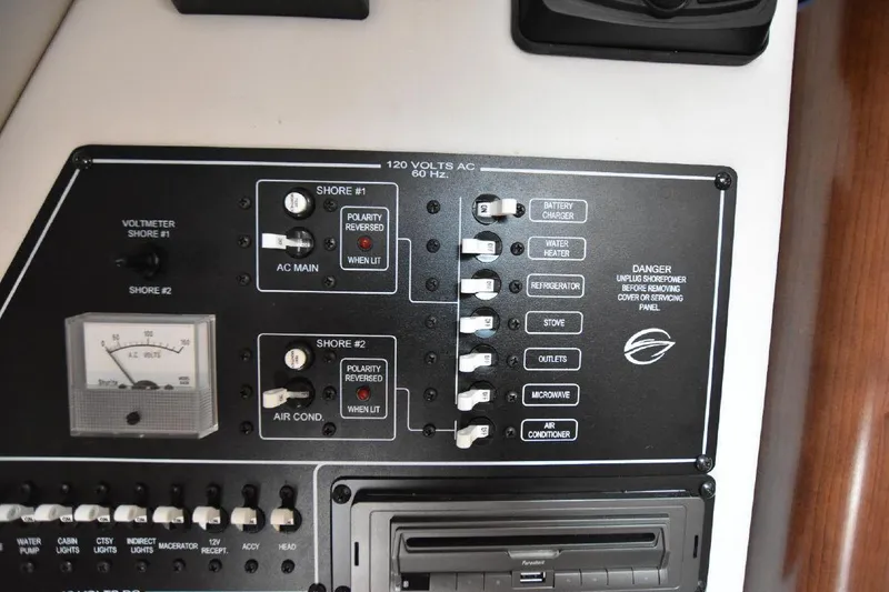 Slide: The Image of Control panel of a 2021 Crownline 264 CR boat with various switches and gauges. - 36
