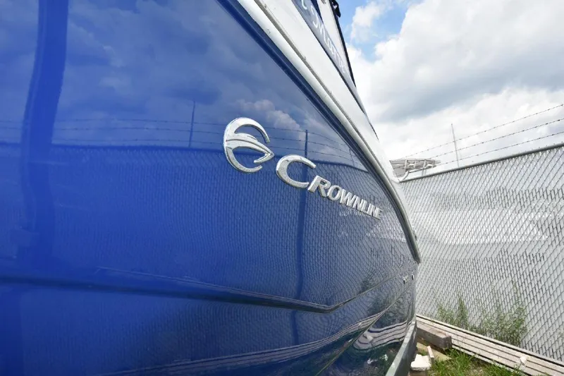 Slide: The Image of 2021 Crownline 264 CR boat with blue exterior and logo. - 44