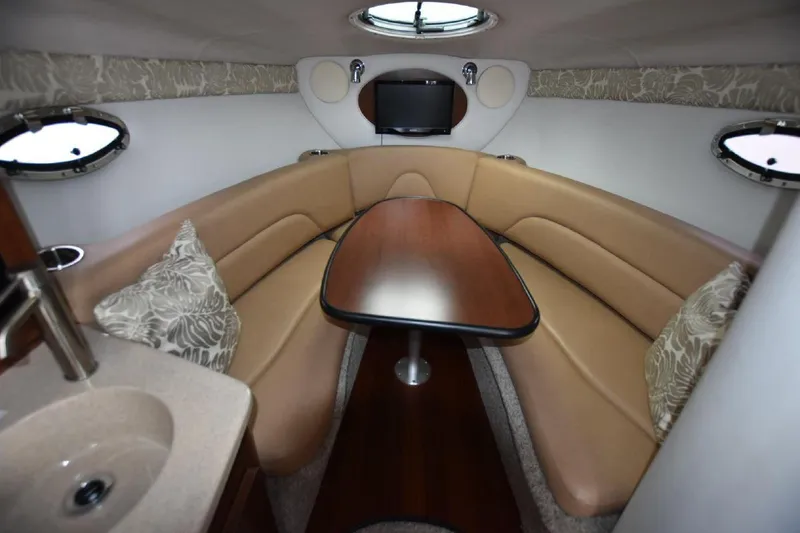 Slide: The Image of Interior of 2021 Crownline 264 CR boat with cozy seating and table. - 5