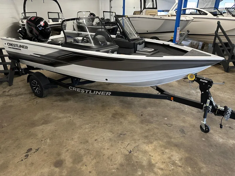 Slide: The Image of 2025 Crestliner 1850 Super Hawk boat on trailer in showroom. - 1