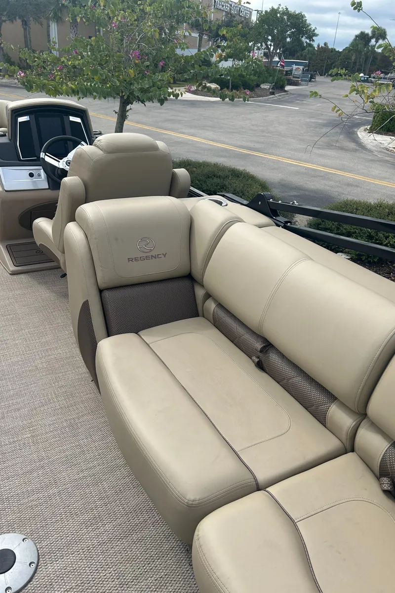 Slide: The Image of 2023 Regency 250 LE3 boat interior with beige leather seating. - 10