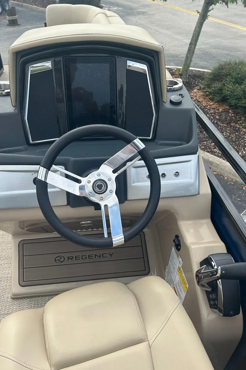 Slide: The Image of 2023 Regency 250 LE3 boat dashboard and steering wheel. - 4