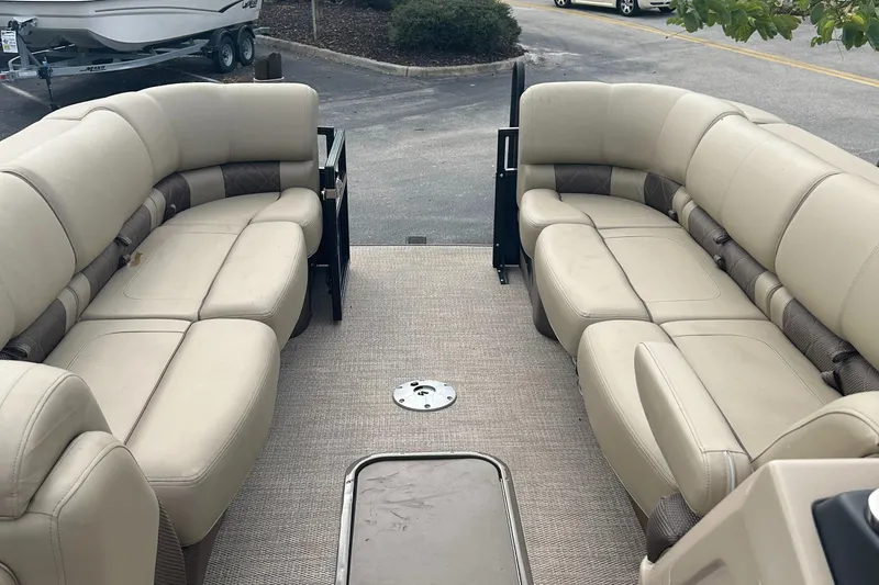 Slide: The Image of 2023 Regency 250 LE3 pontoon boat with beige seating and spacious layout. - 7