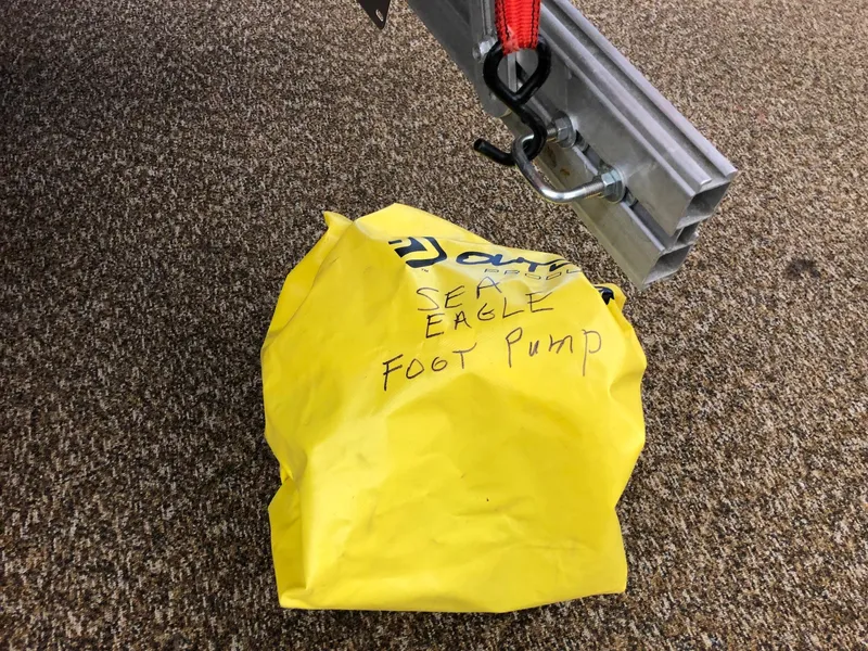 Slide: The Image of Yellow Sea Eagle foot pump bag under trailer hitch. - 5