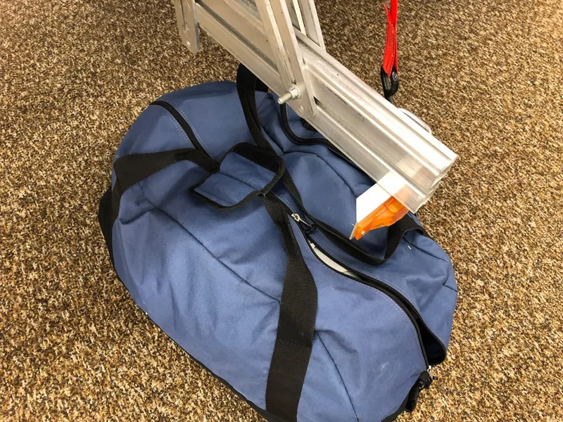 Slide: The Image of Blue duffel bag with Sea Eagle 14' inflatable boat, 2015 model, on carpeted floor. - 6