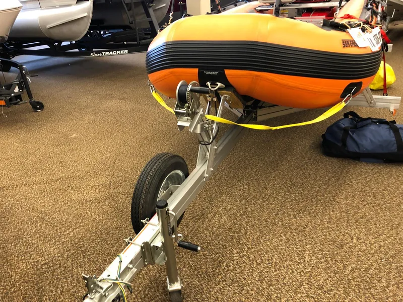 Slide: The Image of 2015 Sea Eagle 14' inflatable boat on a trailer in a showroom. - 7