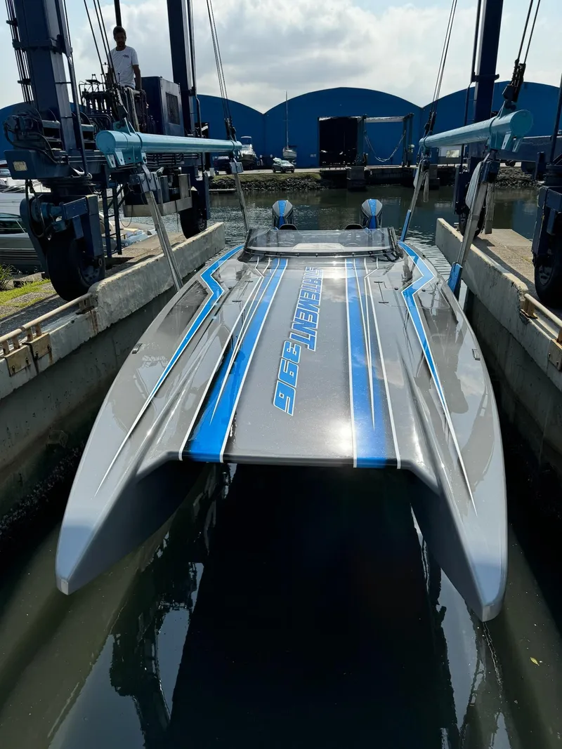 Slide: The Image of 2025 Statement 396 Cat powerboat in dock, featuring sleek design and blue accents. - 10