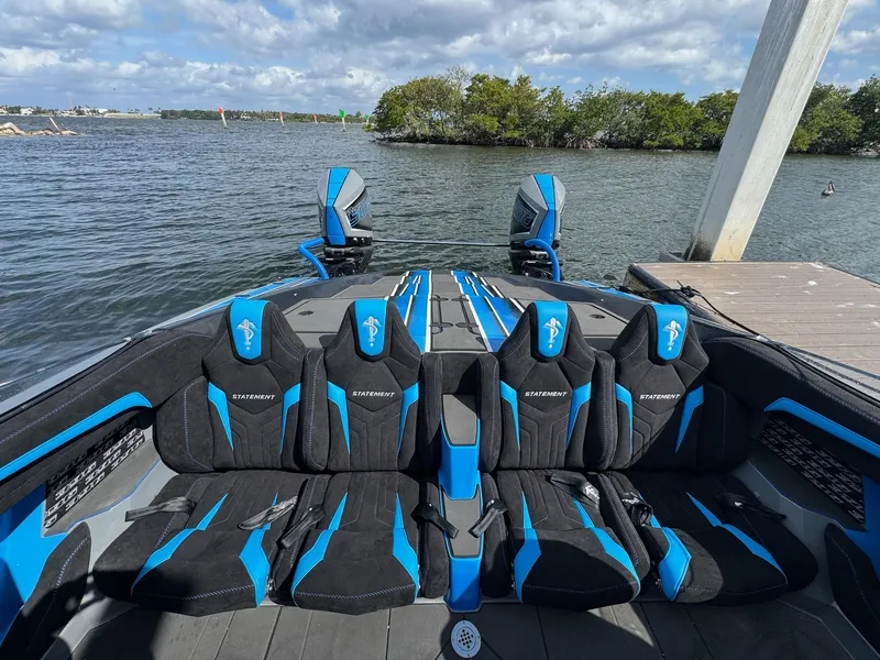 Slide: The Image of Luxury seating on 2026 Statement 396 Cat boat, docked by the water. - 14