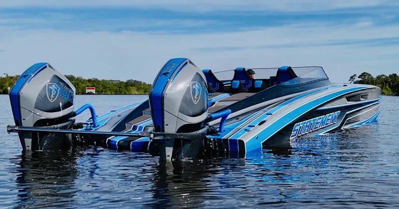 Slide: The Image of 2026 Statement 396 Cat powerboat with dual engines on a calm lake. - 4