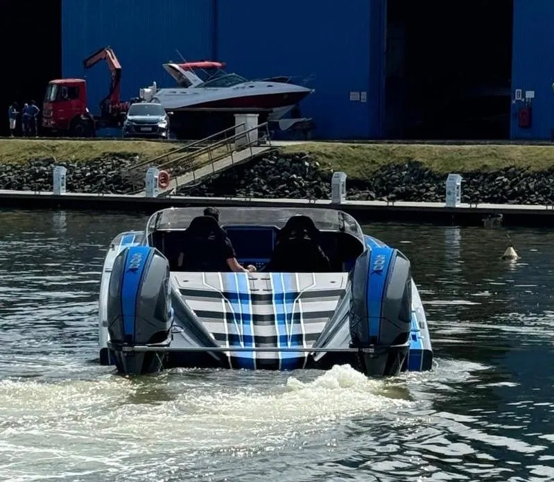 Slide: The Image of 2025 Statement 396 Cat powerboat on water near marina. - 5